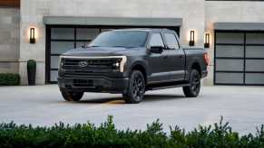 The 2023 Ford F-150 Lightning parked near a home