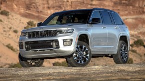 The 2023 Jeep Grand Cherokee off-roading over rocky terrain