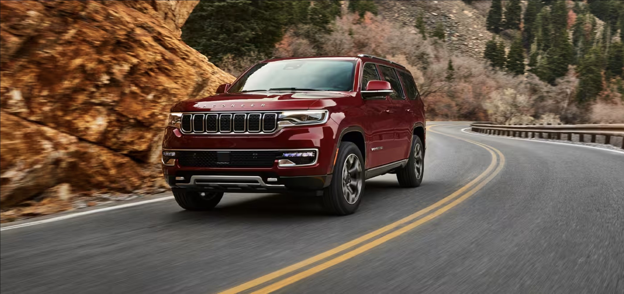 A red 2023 Jeep Wagoneer driving down the road