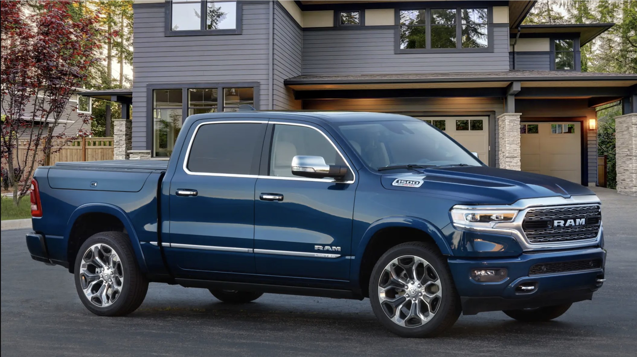 The 2023 Ram 1500 parked near a home