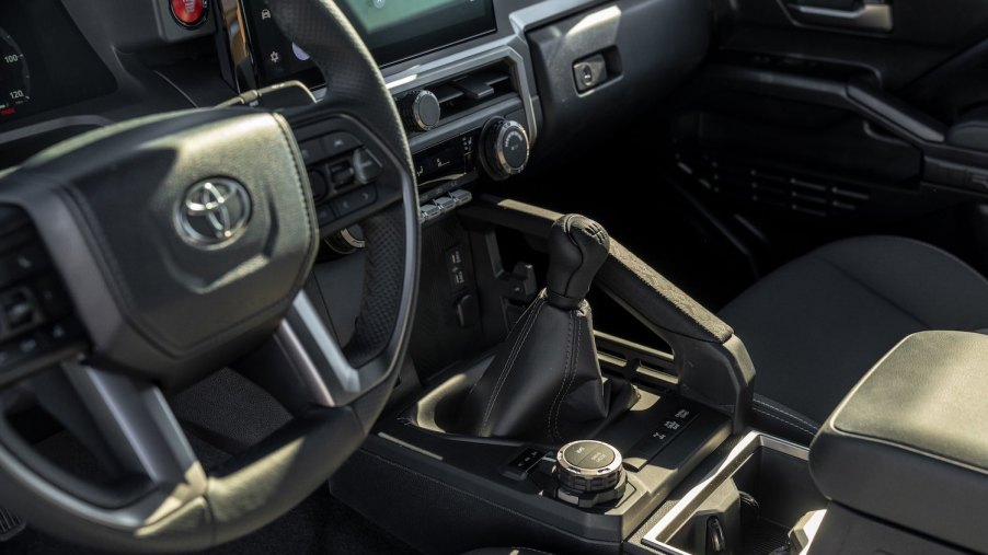 The manual transmission gearshift lever in a 2024 Toyota Tacoma TRD Off Road midsize pickup truck.