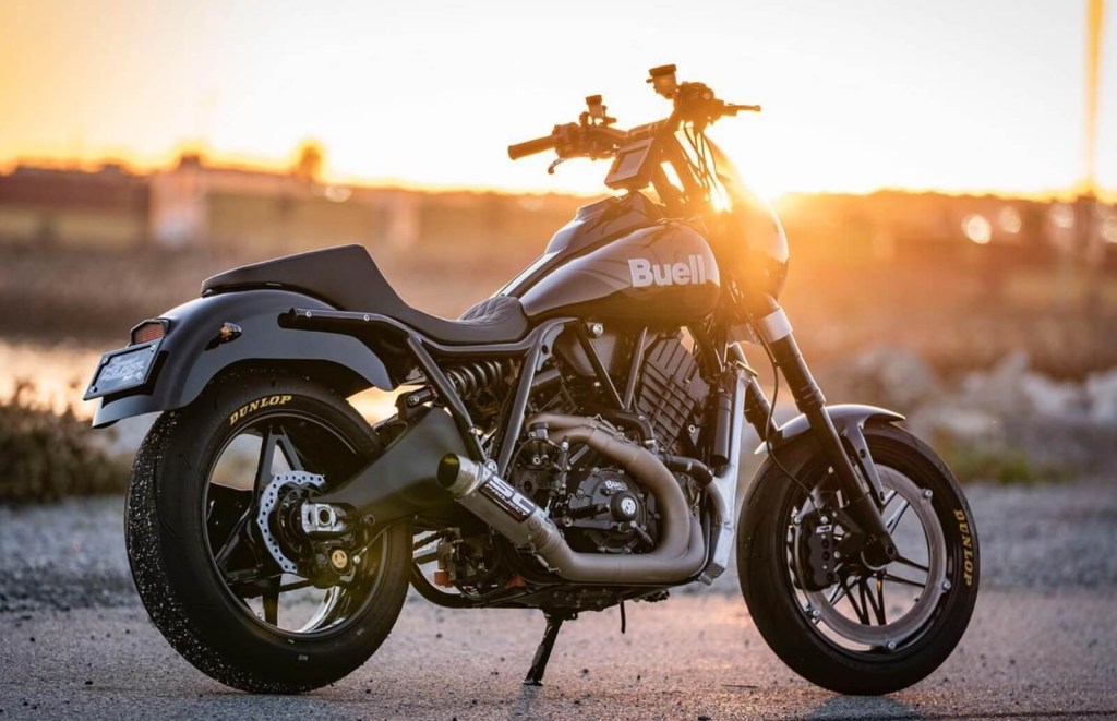 A Buell Super Cruiser sits ahead of a sunset. 