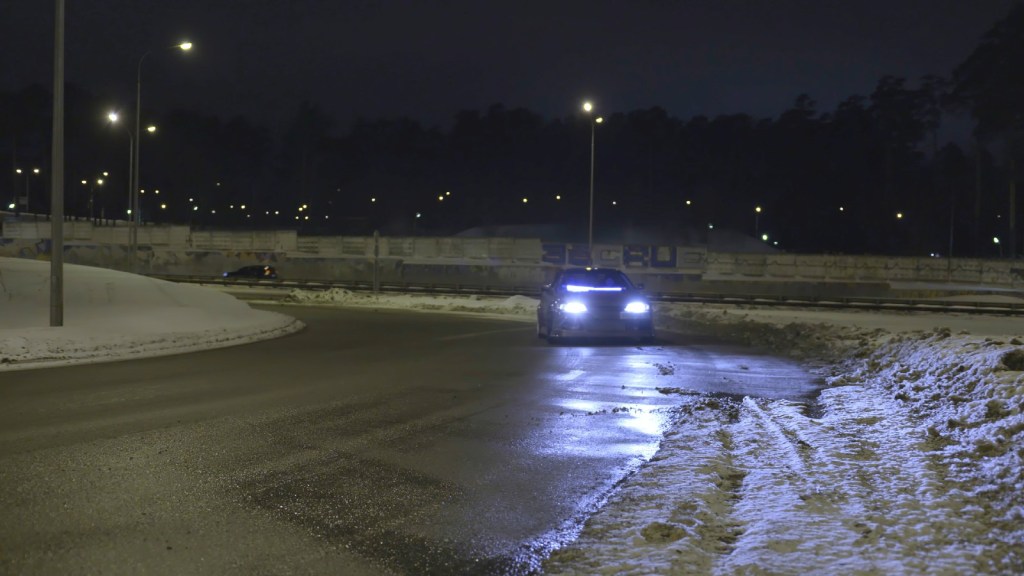 Car Turning Onto an Ice-Covered Road where black ice could be present