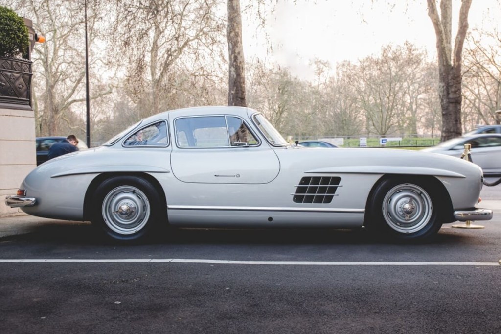 A silver Mercedes-Benz 300SL Gullwing like the one belonging to Jay Leno, sits in a lot.