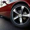 A 2014 Dodge Challenger muscle car shows off its wheels.