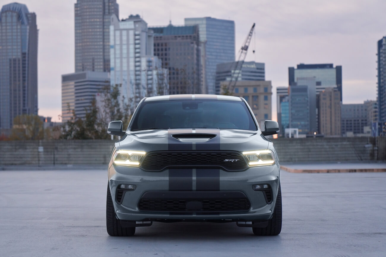 The 2024 Dodge Durango in gray parked in front of a city skyline. This is one of the Dodge SUV models in 2024.