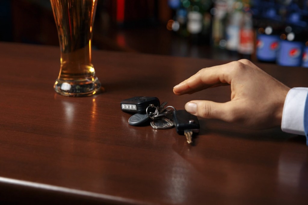 A person reaches for their keys to get home by drunk driving. 