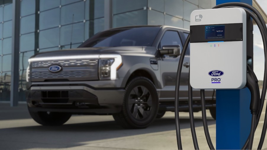 Ford F-150 Lightning parked behind a Ford Pro EV charger.