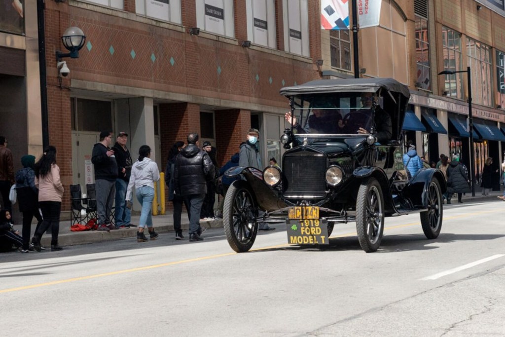 A Ford Model T drives on a public road.