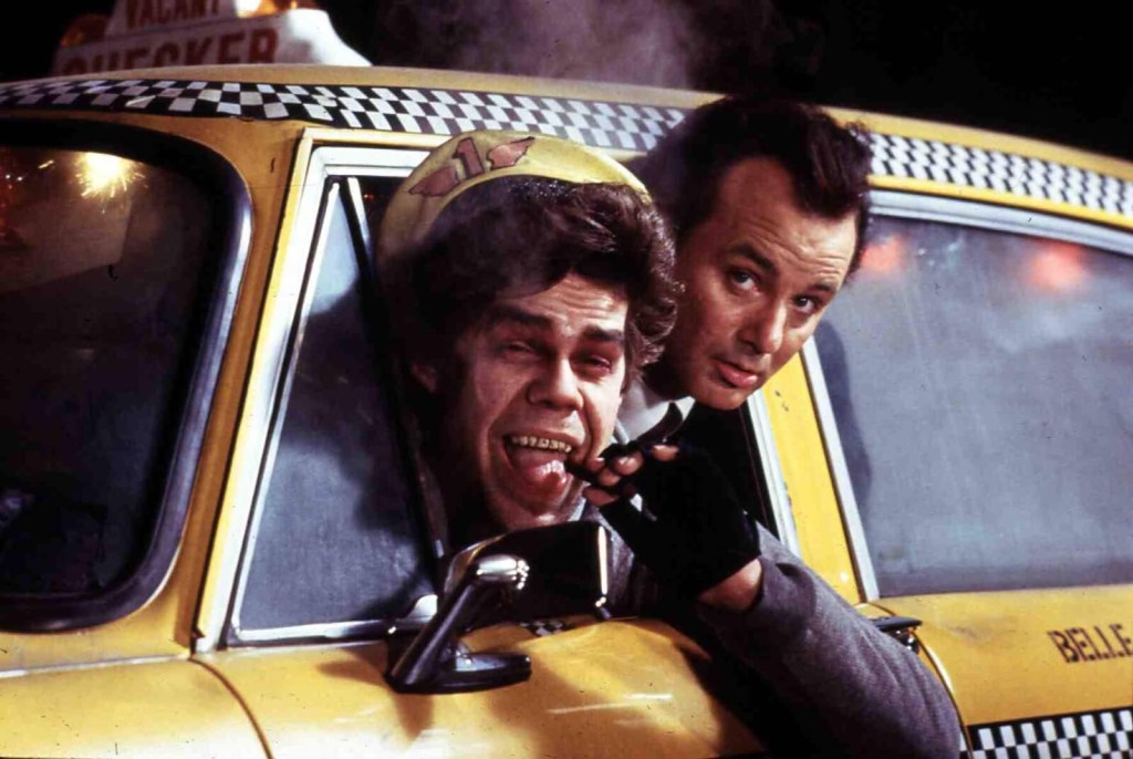 Bill Murray and David Johansen hang out of a car in the 'Scrooged' Christmas movie. 