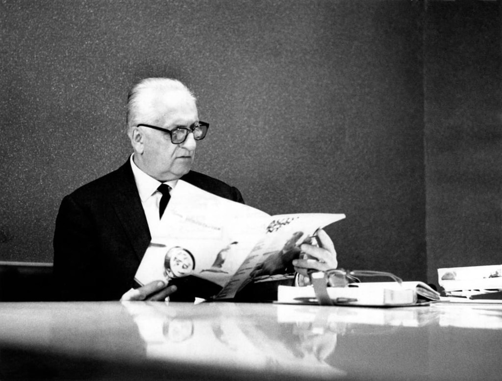 Enzo Ferrari inspects a newspaper.