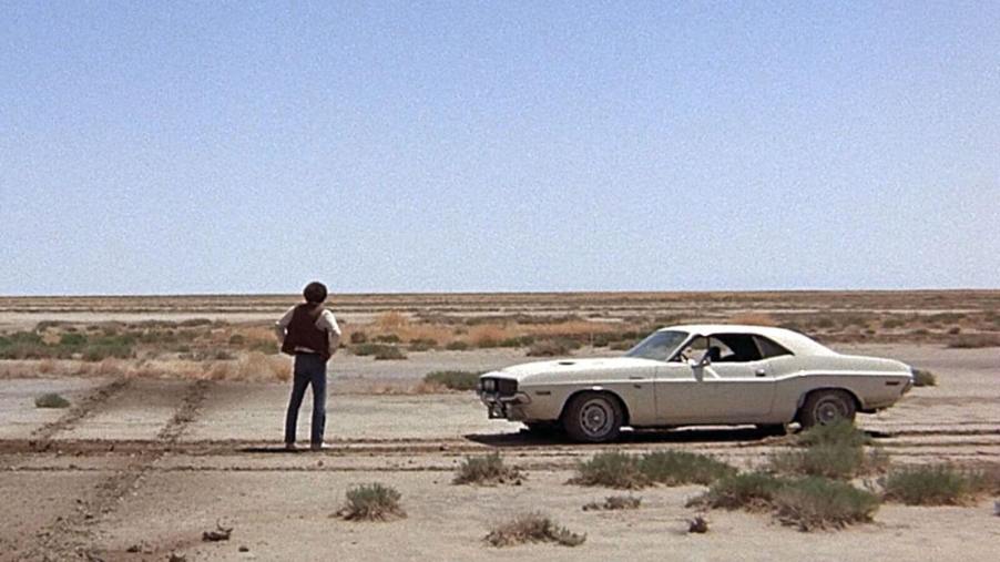 Actor Barry Newman stands in the desert alongside a 1970 Dodge Challenger R/T from the movie 'Vanishing Point'.