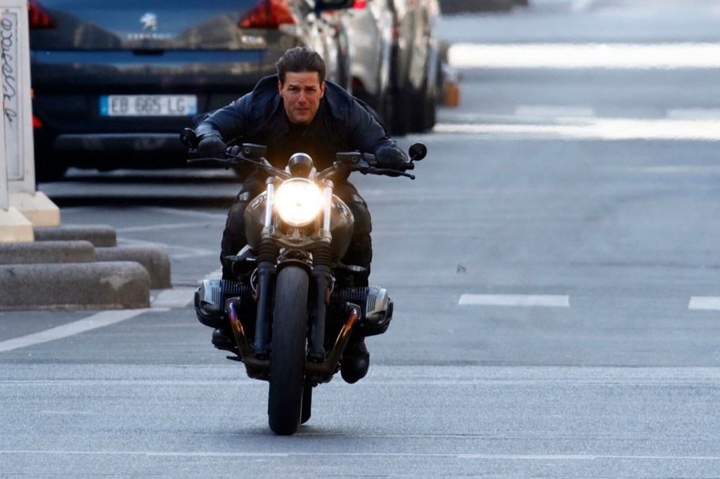 A-list celebrity and motorcycle rider Tom Cruise rides a BMW on the set of a "Mission Impossible" film.
