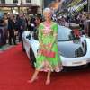 Dame Helen Mirren poses on the red carpet in front of a McLaren supercar during the Hobbs and Shaw Fast and Furious premiere