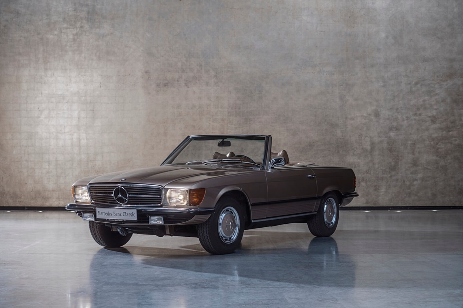 A Mercedes-Benz R107 350SL sits in a studio. 