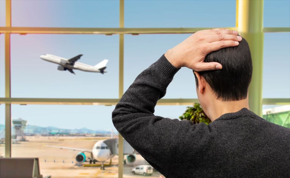 A man who didn't observe travel tips is sad at having missed his airplane.