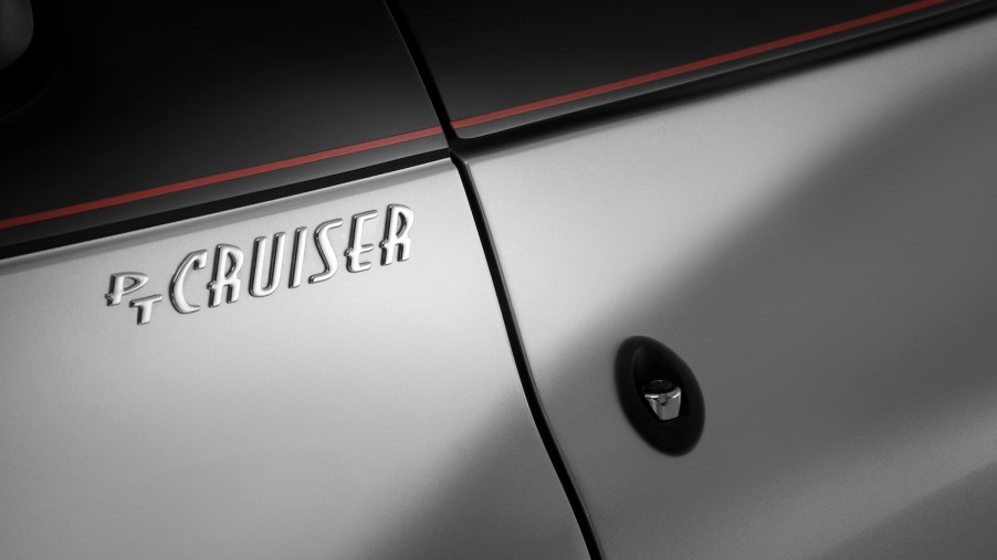 The chrome "PT Cruiser" logo on the door of a Chrysler
