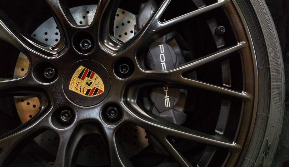 Porsche badge logo in the center of a rim.