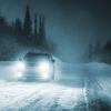 SUV Driving In Winter Weather at night. There could be black ice on the road.