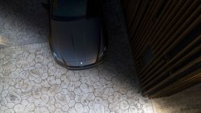 A Maserati Quattroporte, the model with the highest depreciation rate, parks in the shadows.