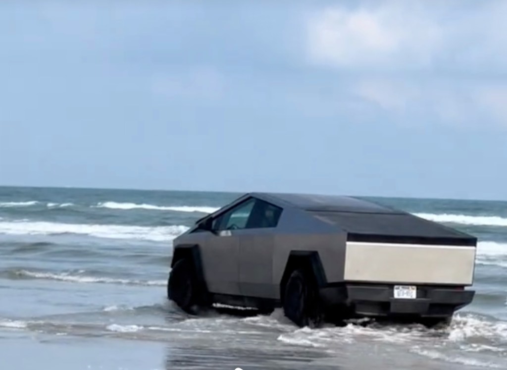 The Tesla Cybertruck driving in the ocean during a test drive of the EV pickup.