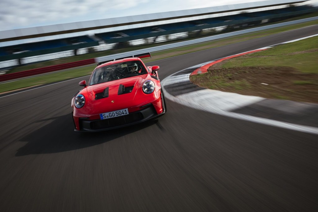 A red Porsche 911 GT3 RS takes a corner. 