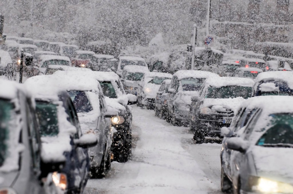 Winter vacation travelers stack up in holiday traffic and snow.