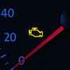A yellow check engine fault icon is shown illuminated on a speedometer