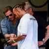 Brad Pitt stands closely to Lewis Hamilton in the garage at F1 Grand Prix of USA at Circuit of The Americas on October 23, 2022 in Austin, Texas