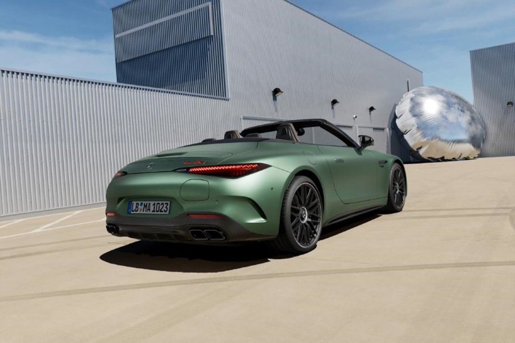 A green 2024 Mercedes-AMG SL 63 S E Performance shows off its rear-end styling. 