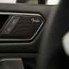 A Volkswagen Tiguan door panel features a Fender car speaker