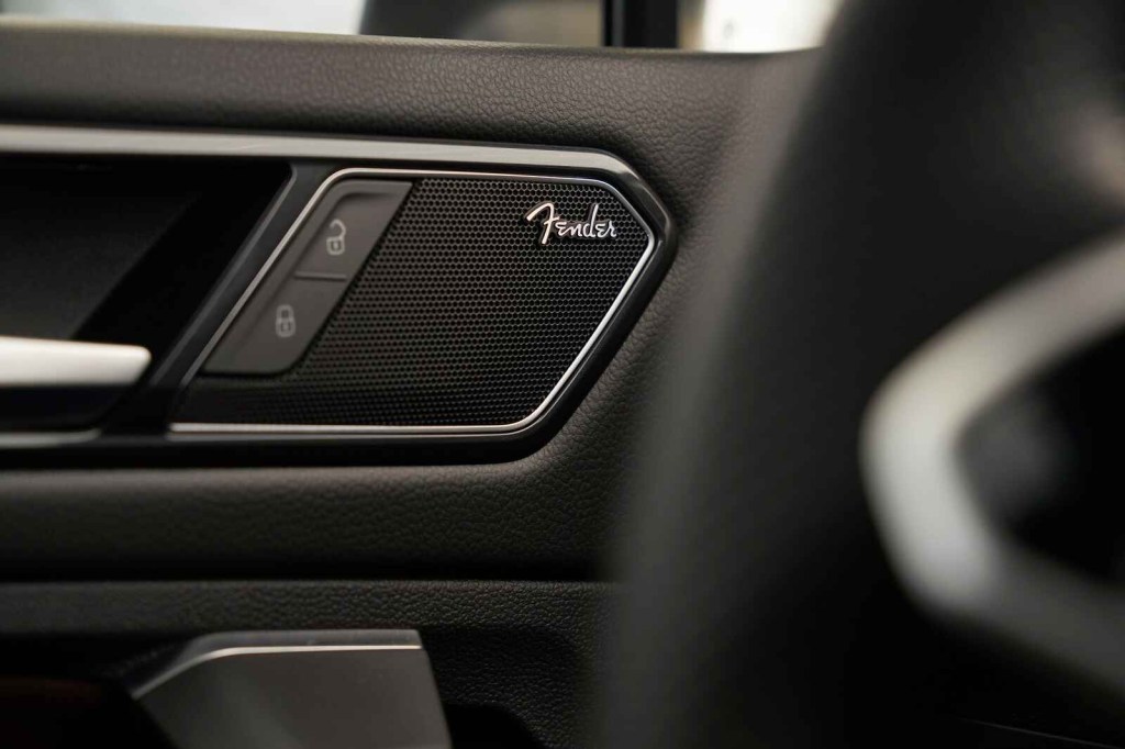 A Volkswagen Tiguan door panel features a Fender car speaker