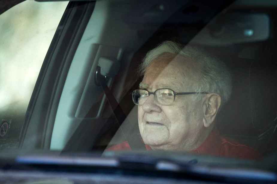 A close up of Warran Buffet riding in a car