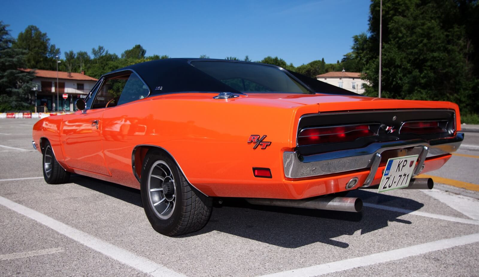 A HEMI Orange 1968 Dodge Charger hangs out at a Mopar car show. 
