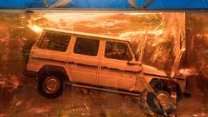 A white 1979 Mercedes-Benz G-Class 280 GE sealed in a resin cube at the Detroit Auto Show in 2018