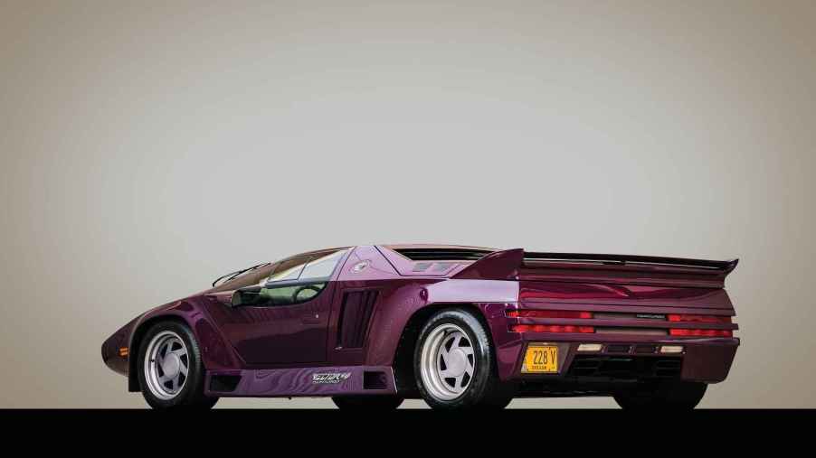 A purple 1991 Vector W8 Twin Turbo is shown in left rear angle view