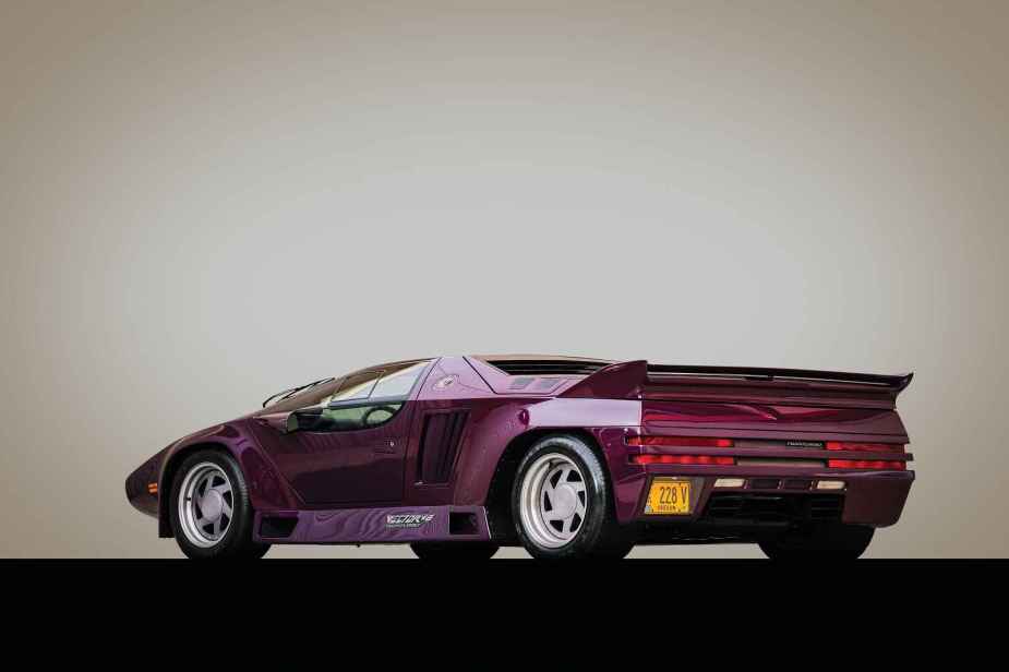 A purple 1991 Vector W8 Twin Turbo is shown in left rear angle view