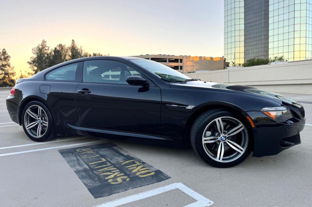 Black BMW M-class coupe parked atop a parking garage.