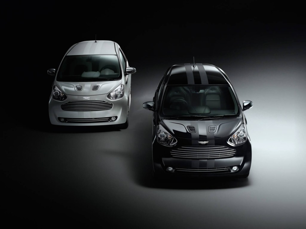 A black and white Aston Martin Cygnet sit on a stage. 