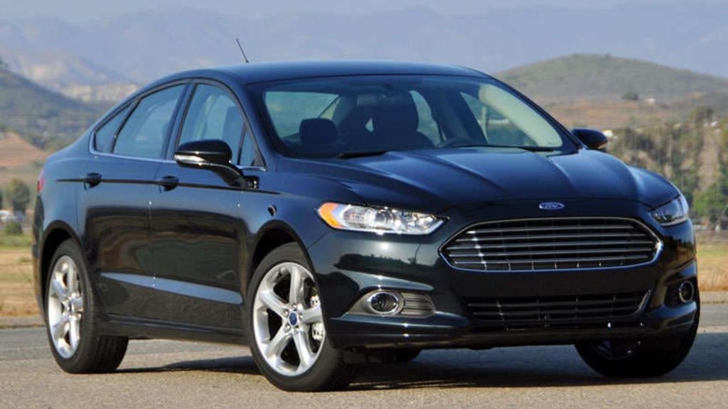 The 2014 Ford Fusion could be a good used car and is priced under $10,000. This model is posed on a dirt road.