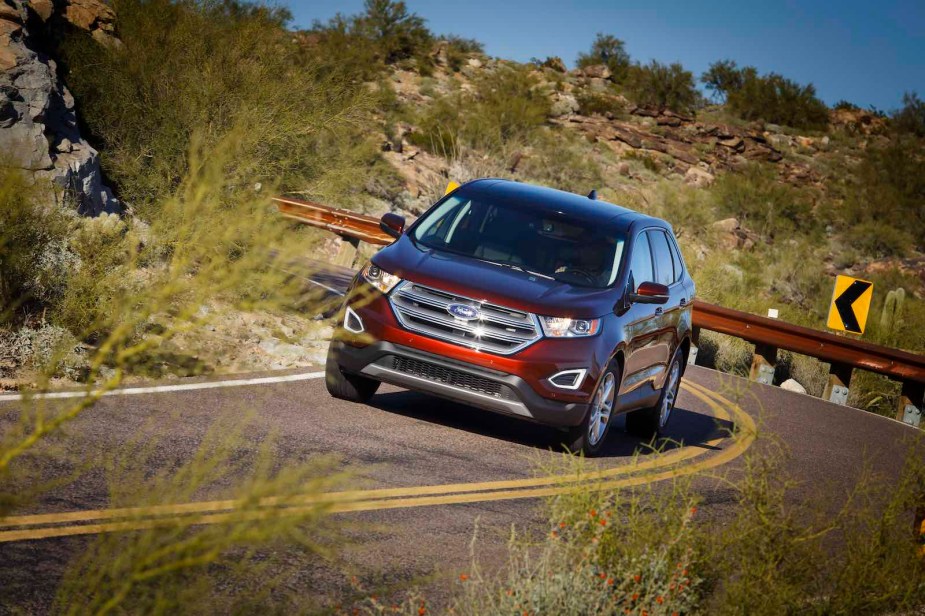 Ford Edge crossover SUV driving on a winding road.