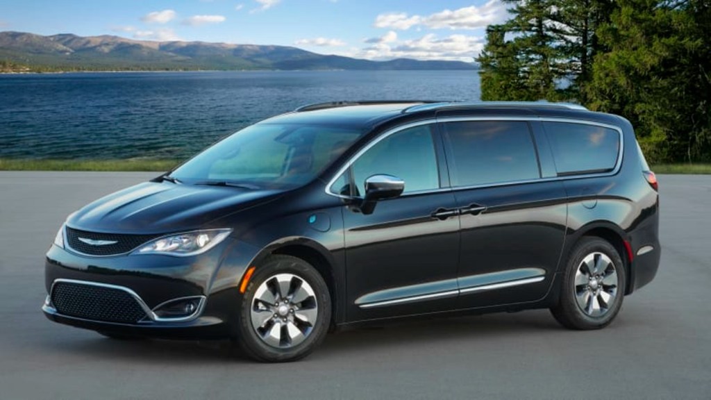 2020 Chrysler Pacifica driving on a road. This Pacifica is a low-rated used minivan.