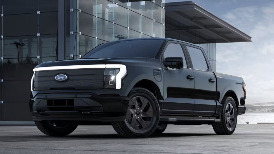 The 2023 Ford F-150 Lightning near a building