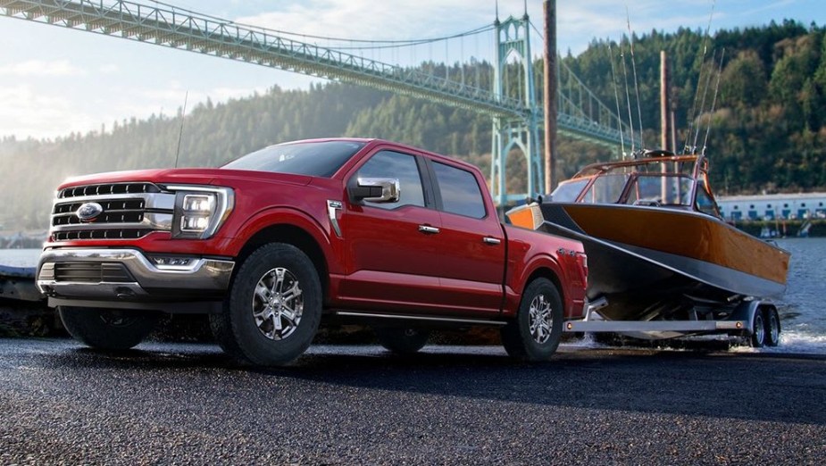 The 2023 Ford F-150 backing a boat into water