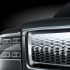 The stacked headlights, chrome grille, and custom logo of the Toyota Century luxury SUV.