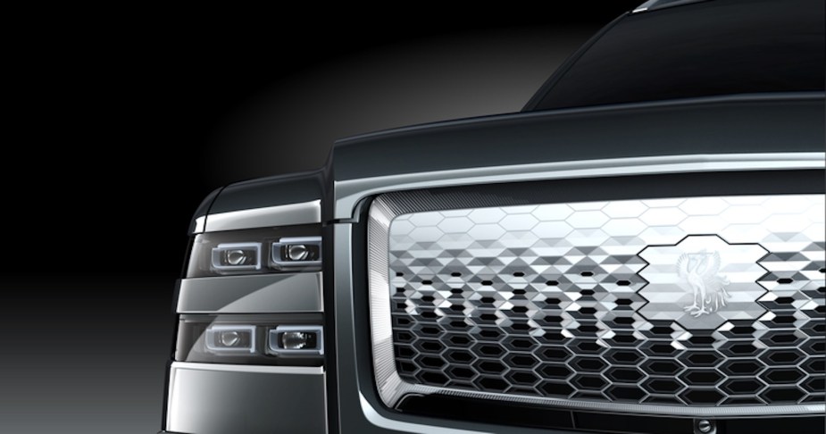The stacked headlights, chrome grille, and custom logo of the Toyota Century luxury SUV.