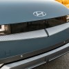 The front emblem of a blue-green 2023 Hyundai Ioniq 5 in close front end view