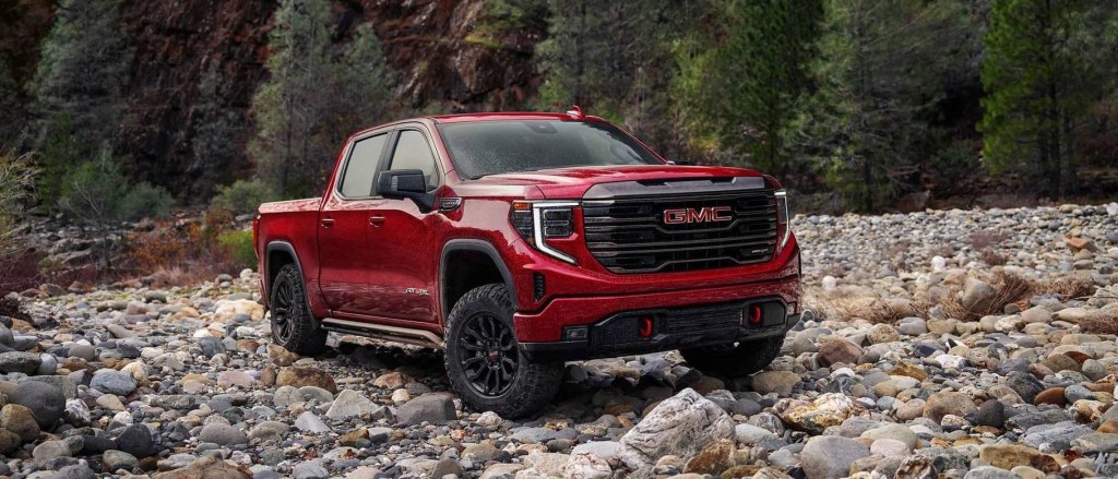The 2024 GMC Sierra off-roading over rocky terrain