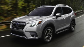 Silver 2024 Subaru Forester On The Road. This is one of the top-rated compact SUVs.
