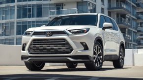 White 2024 Toyota Grand Highlander midsize SUV posed. This Toyota SUV can be equipped with the Hybrid Max powertrain.